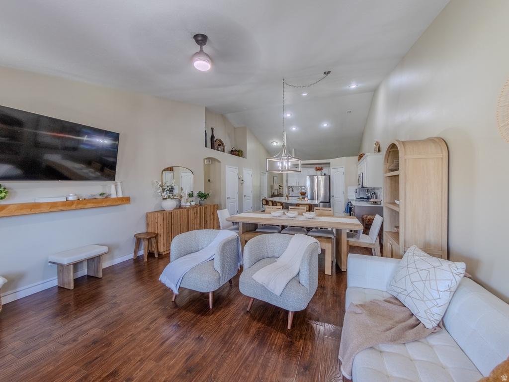 Open-concept living space featuring wood-finish flooring, recessed lighting, and a vaulted ceiling