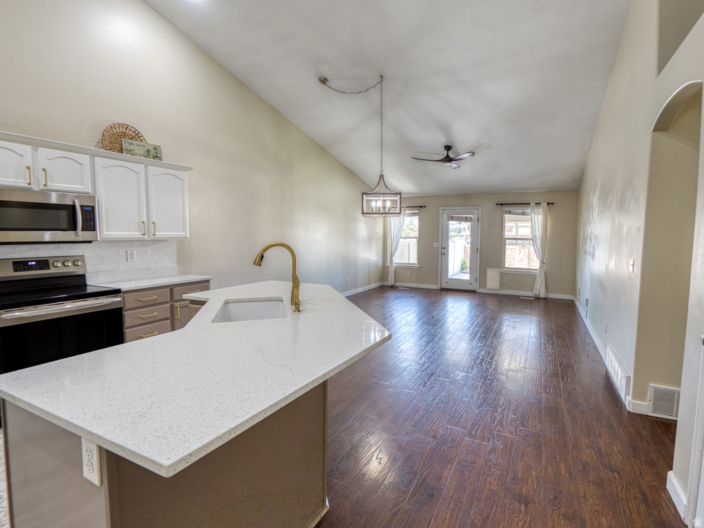 Kitchen island with a white speckled countertop and an undermount sink