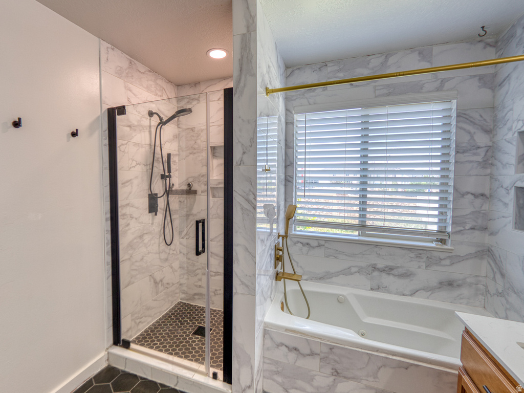 Contemporary bathroom featuring a walk-in shower with black-framed glass enclosure, hex tile flooring, and built-in shelving