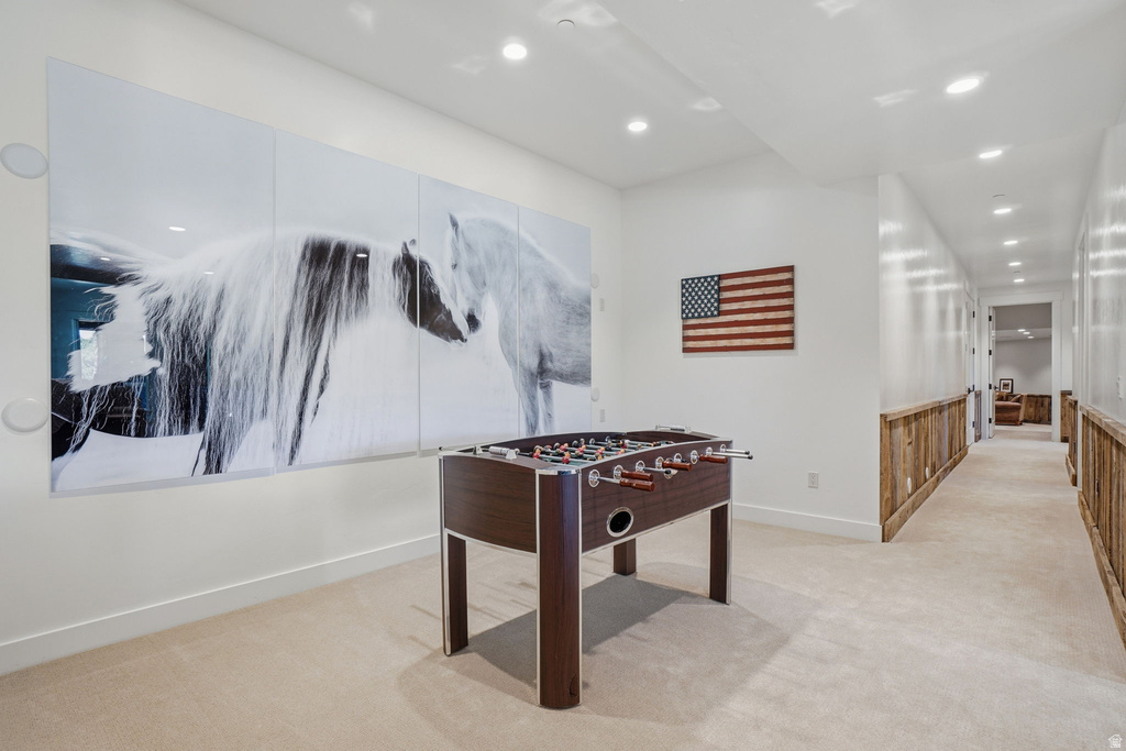 Recreational space featuring recessed lighting, plush carpeting, and wainscoting with a natural wood finish