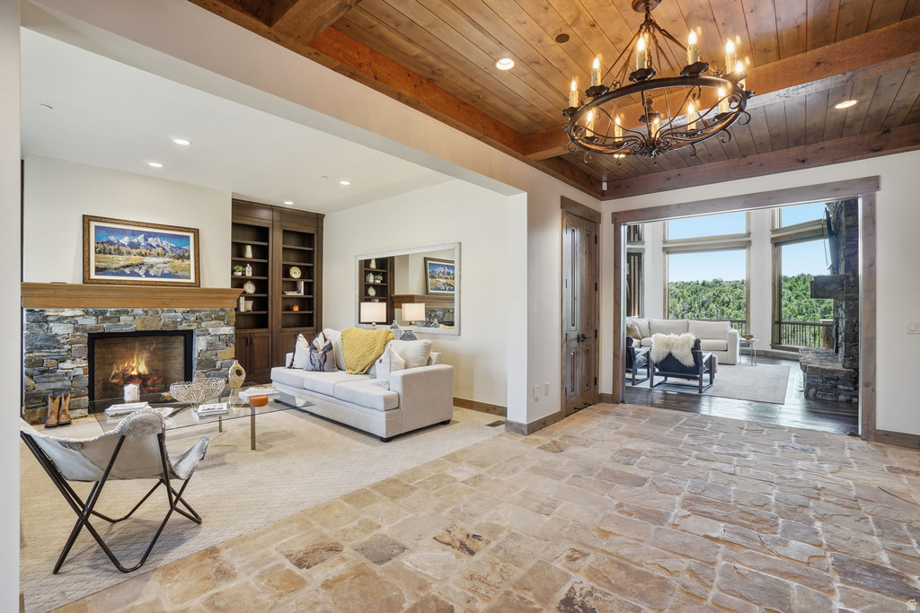 Spacious interior with stone flooring, a wood plank ceiling, and exposed wood beams