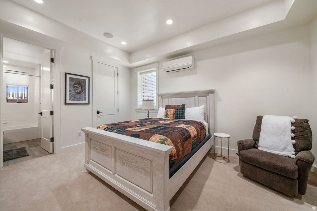 Carpeted room featuring a window with blinds, recessed lighting, and an air conditioning unit