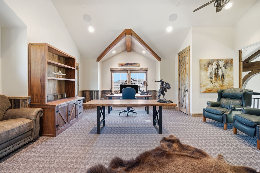 Vaulted ceiling room featuring exposed wood beams and wainscoting