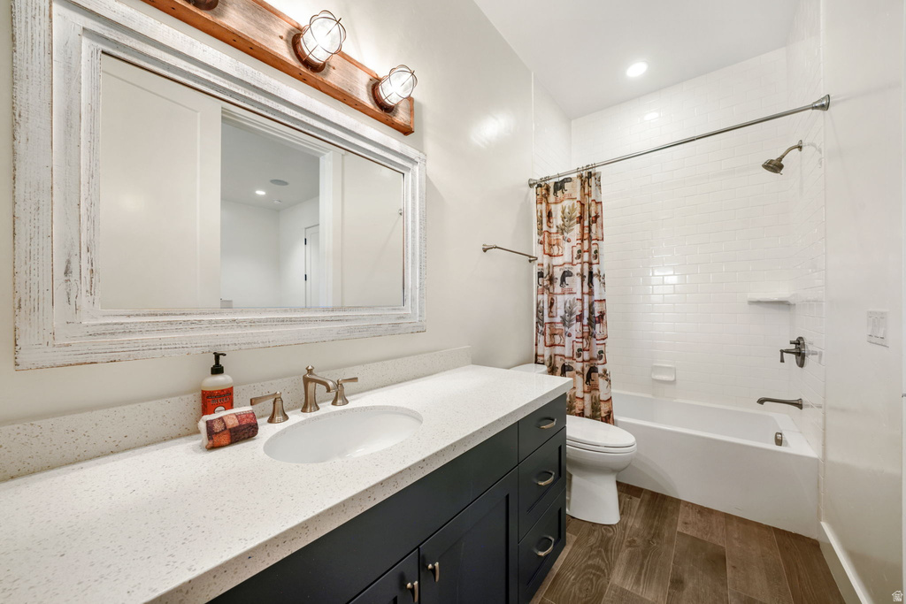Bathroom featuring a white subway tile shower surround, a built-in bathtub, and wood-finish flooring