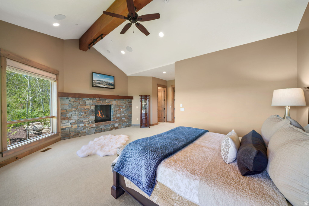 Vaulted ceiling with an exposed wood beam and ceiling fan