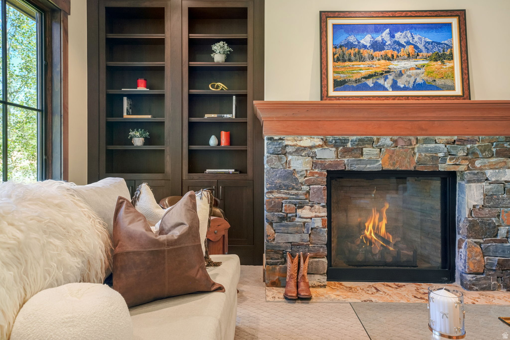 Stone-clad fireplace with a wood mantel and hearth