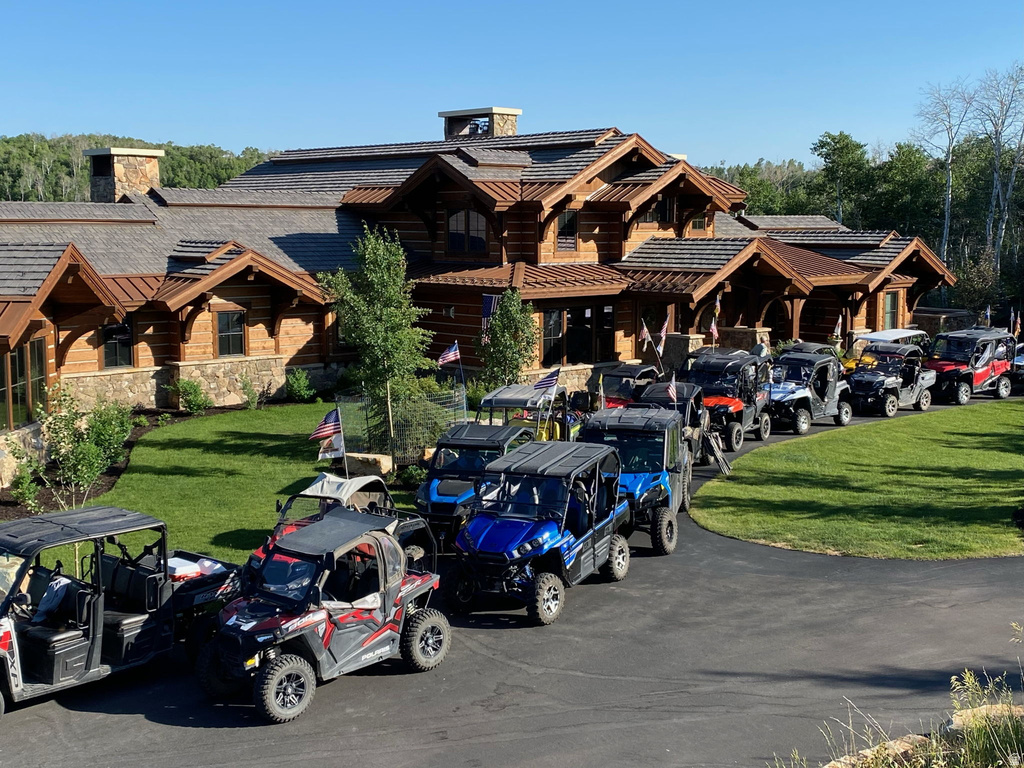 Distinguished log home featuring a multi-gabled roofline with cedar shake shingles and copper accents