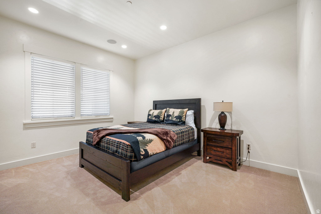Light-filled room featuring two windows with white blinds, recessed ceiling lighting, and neutral carpeting