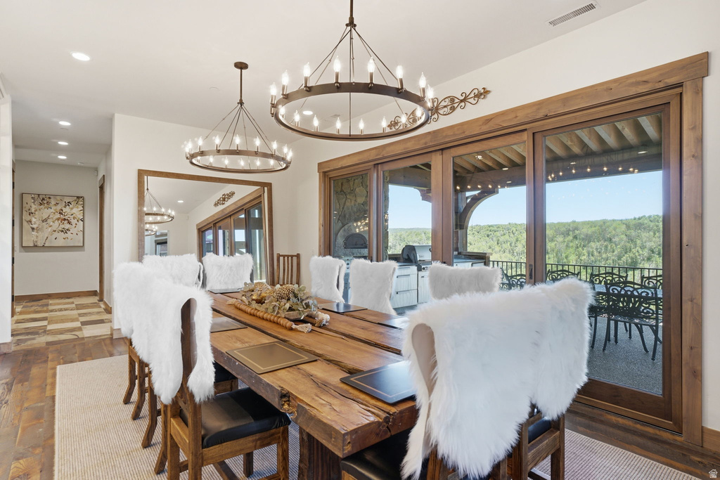 Wood-finish flooring and a natural wood dining table with seating for eight define this space