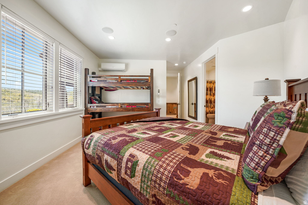 Bedroom featuring two windows with white blinds, a built-in bunk bed, an air conditioning unit, recessed lighting, and soft carpeting