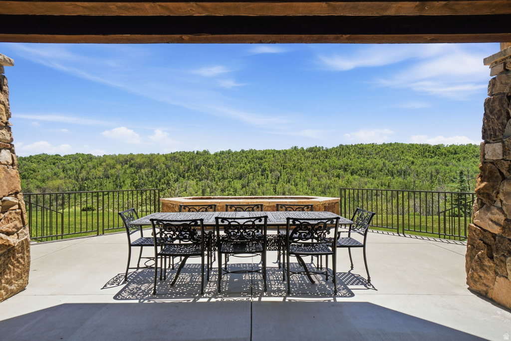 Spacious outdoor patio featuring stone columns and a concrete surface