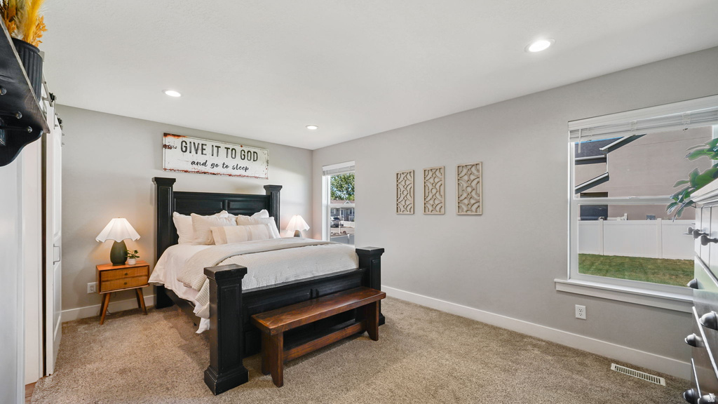 Carpeted room with recessed lighting and neutral wall tones