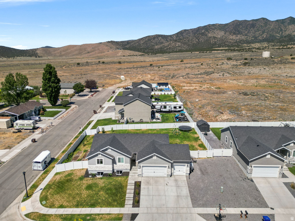 Contemporary single-story residence featuring a light gray exterior with white trim and a dark gray shingle roof