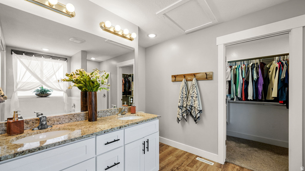 Double vanity with granite-finish countertop, two undermount sinks, and matte black faucets