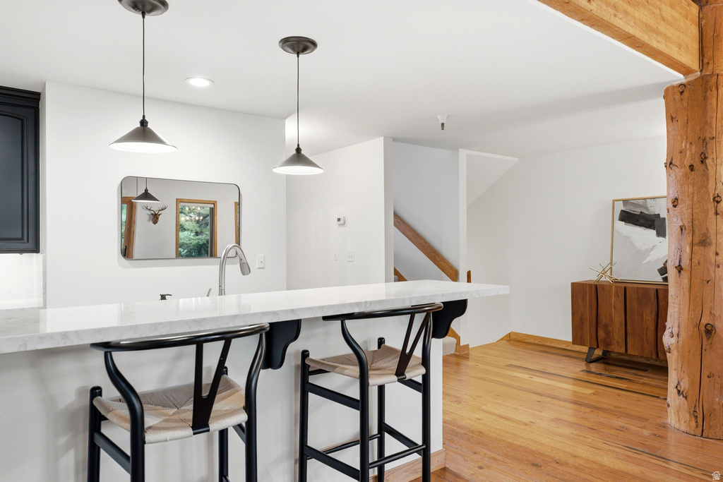 Kitchen island with a white countertop and two pendant lights