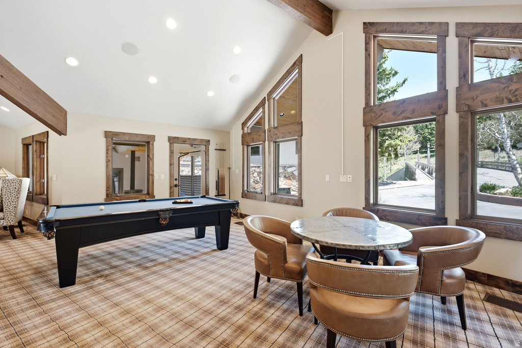 Recreation room featuring a pool table, high vaulted ceilings with exposed wood beams, recessed lighting, and large picture windows with wood trim