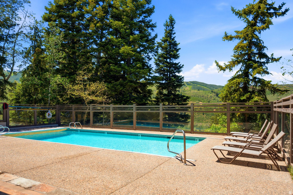 Outdoor swimming pool with an exposed aggregate deck and stainless steel handrails