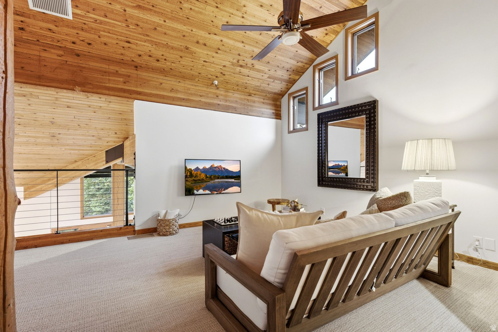 Vaulted wood-paneled ceiling with a ceiling fan