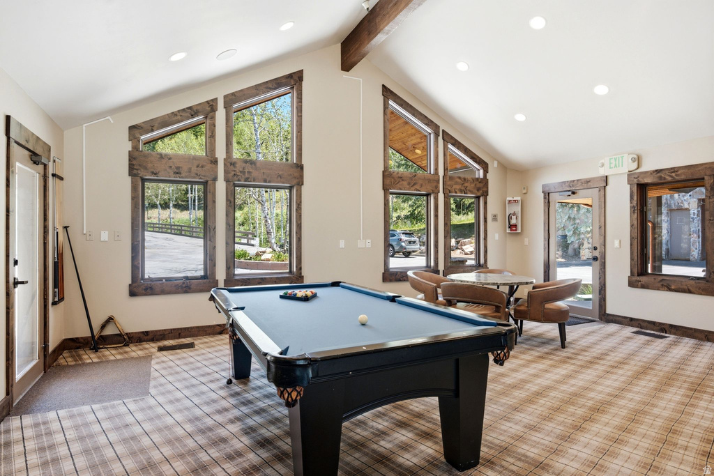 Recreation room featuring a pool table, vaulted ceilings with exposed wood beams, recessed lighting, and large windows with rustic wood trim