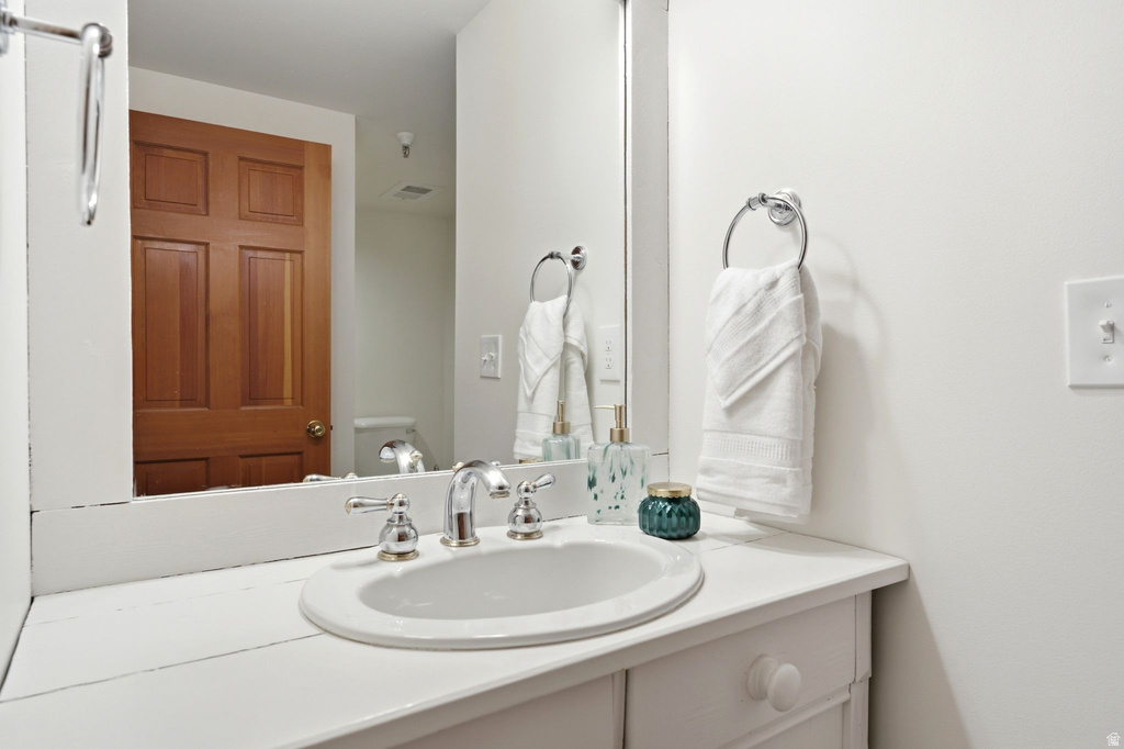 Bathroom vanity with a white countertop and integrated oval sink