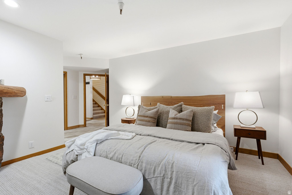 Carpeted sleeping area with white walls and wood trim