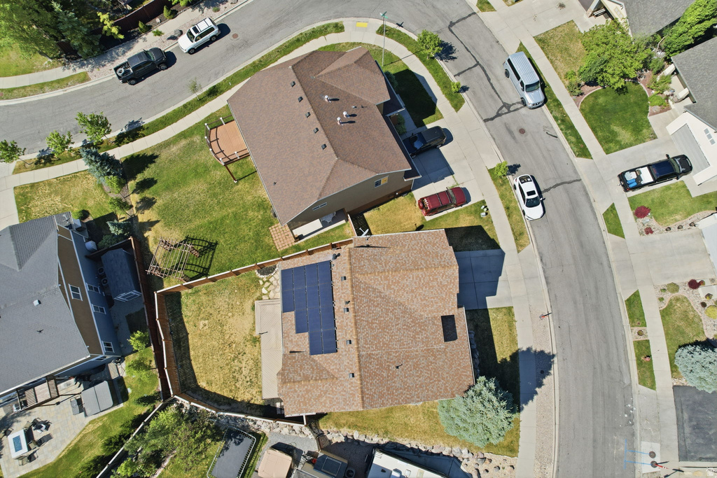 Aerial perspective of a neighborhood featuring residential properties with brown shingle roofs