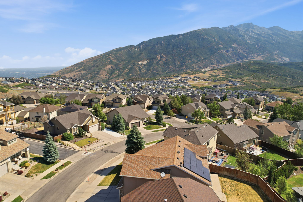 Neighborhood setting featuring a mountain backdrop and distant body of water