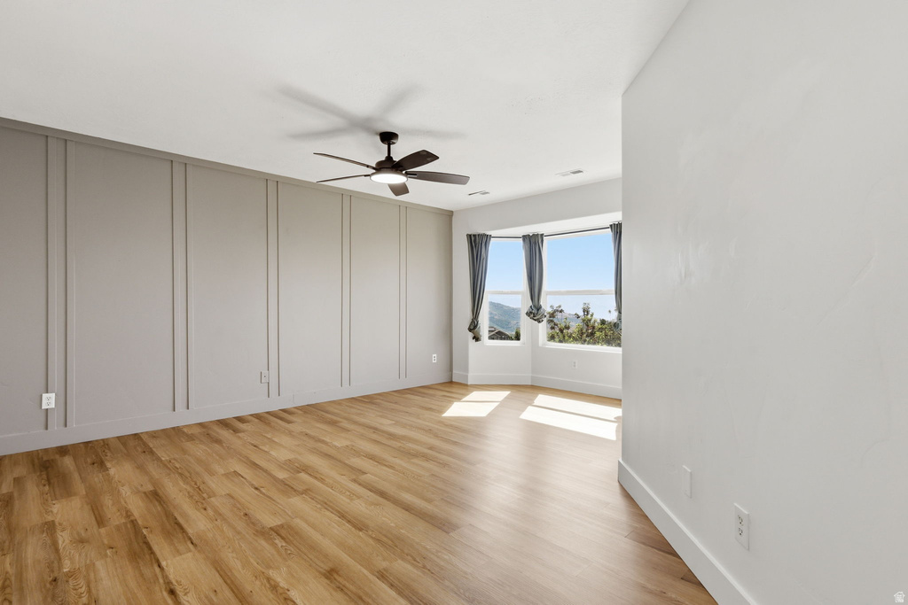 Hardwood-finish flooring complementing a feature wall with vertical panel molding