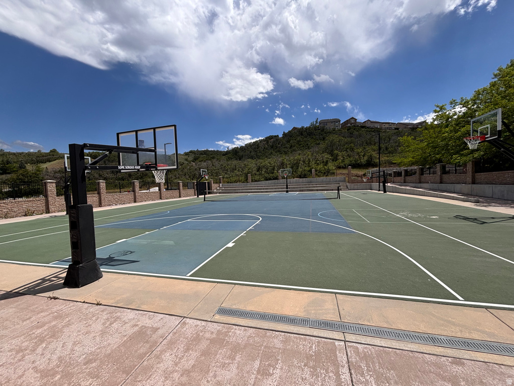 Multi-sport court featuring dedicated basketball and tennis areas, clear court markings, and multiple hoops