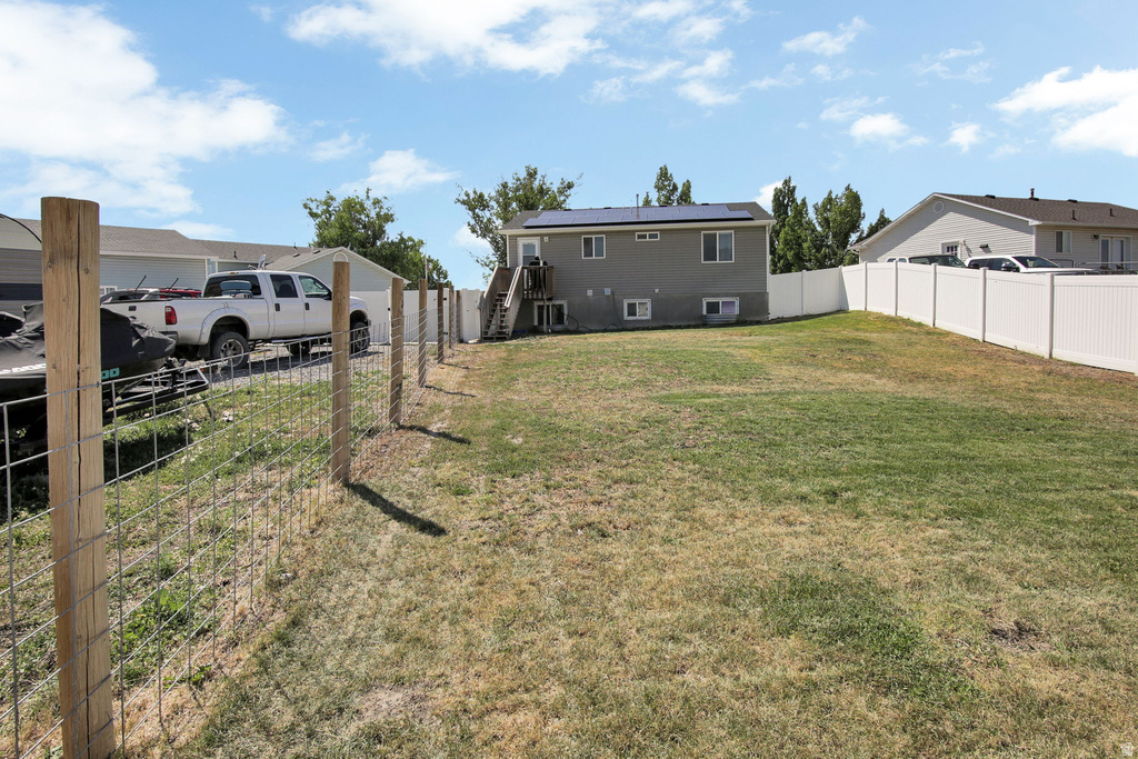 Expansive backyard with a partial wire and wood post fence