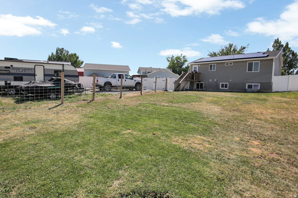 Expansive lawn area with a partial privacy fence