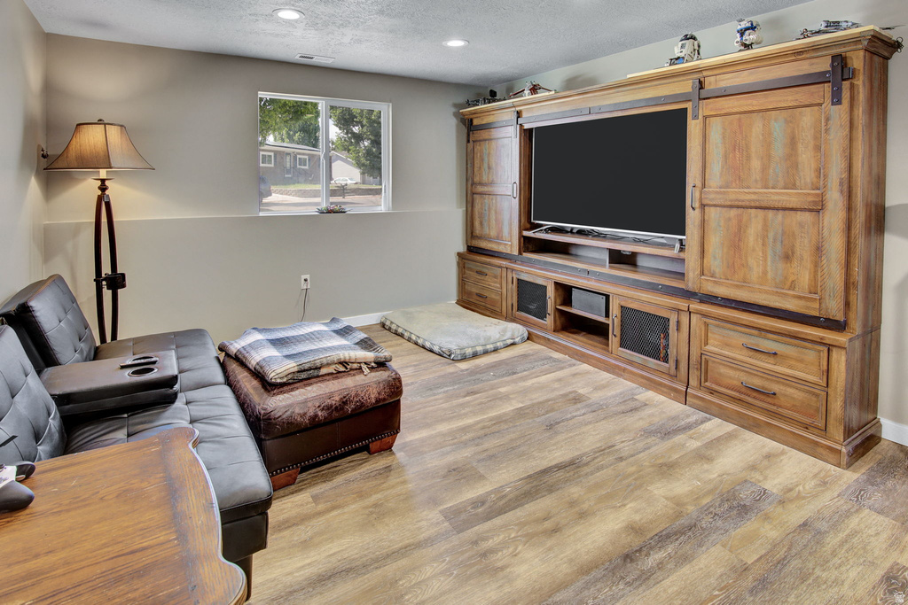 Built-in entertainment center featuring wood-finish cabinetry and sliding barn doors