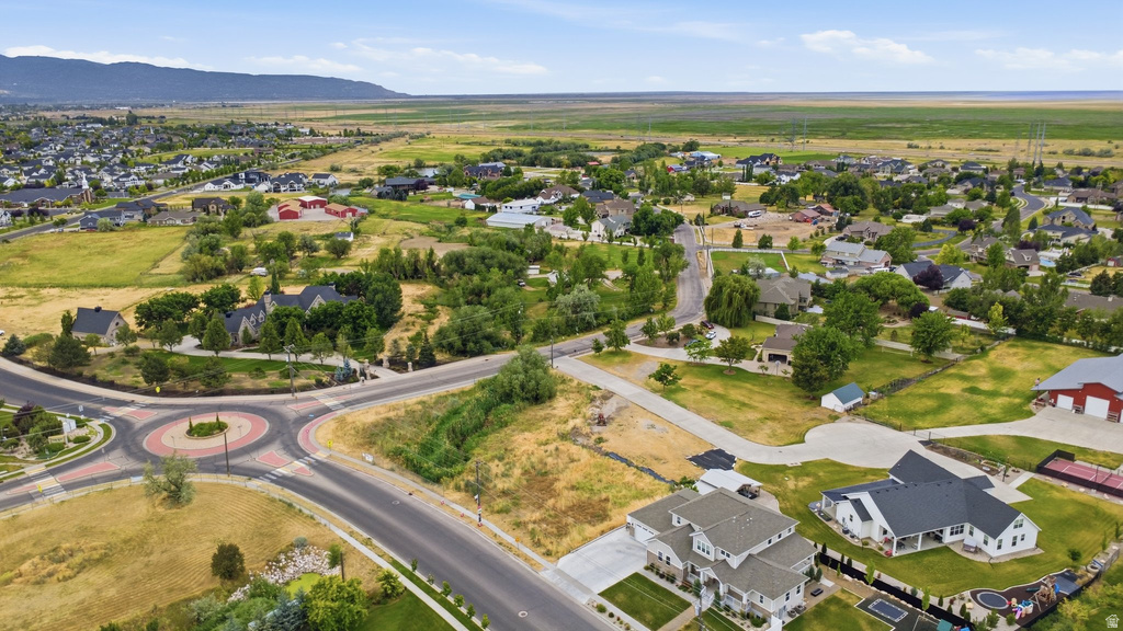 Expansive residential development featuring a diverse collection of homes, mature trees, and a clear blue sky