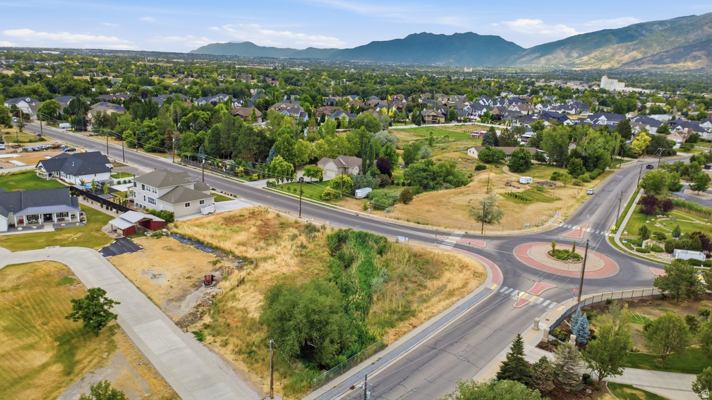 Expansive undeveloped lot featuring street frontage, a concrete driveway approach, and surrounding mature trees