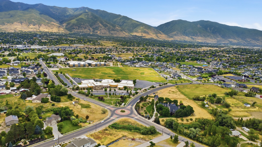 Expansive aerial perspective showcasing a residential community situated against a prominent mountain range