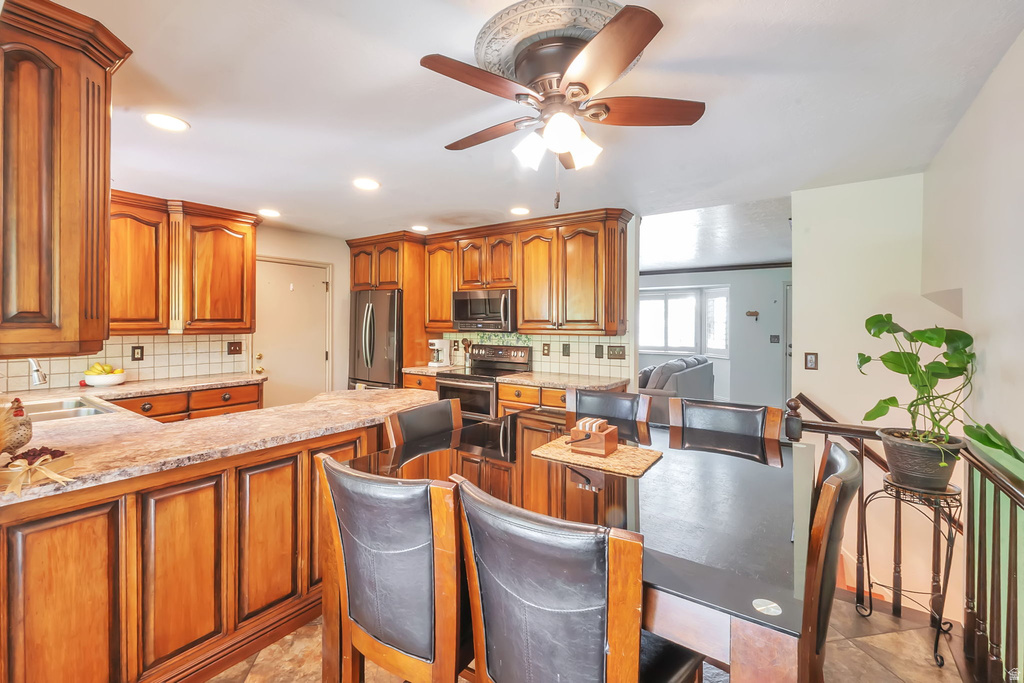 Kitchen featuring wood cabinetry, light-toned countertops, and a tile backsplash