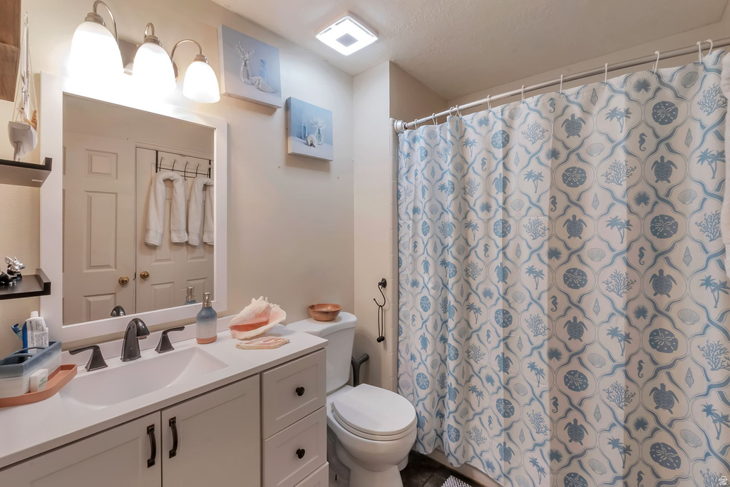 Modern bathroom featuring a white vanity with integrated sink, dark bronze-finish faucet, and a large framed mirror