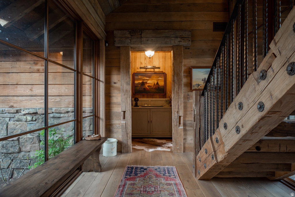 Rustic-inspired interior featuring exposed wood beams and plank walls
