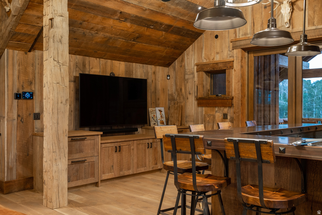 Vaulted ceiling featuring wood planking and exposed wood beams