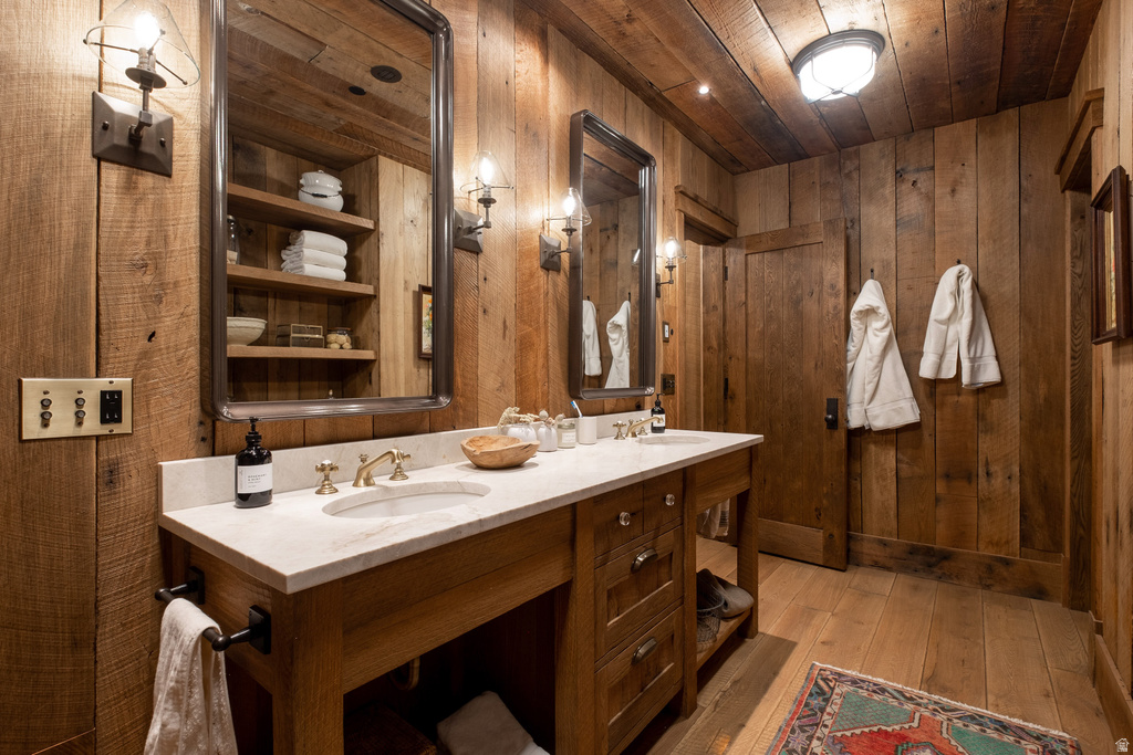 Double vanity with undermount sinks, brass-finish fixtures, and a light-toned countertop