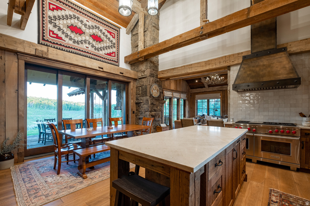 Open-concept living space with exposed wood beams and a stone-clad structural column