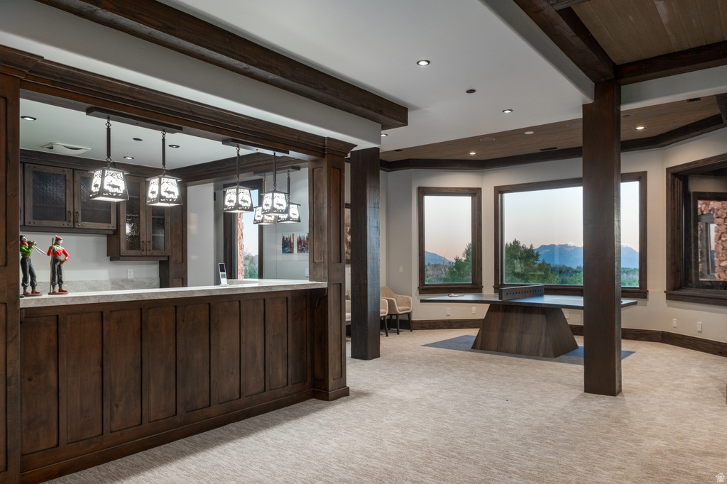 Spacious interior featuring a built-in wet bar with dark wood cabinetry and a light-toned countertop