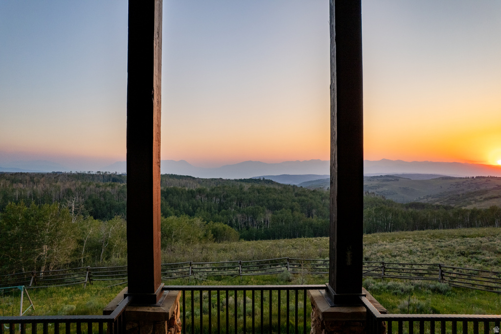Expansive mountain and forest scenery observed from a covered outdoor living space