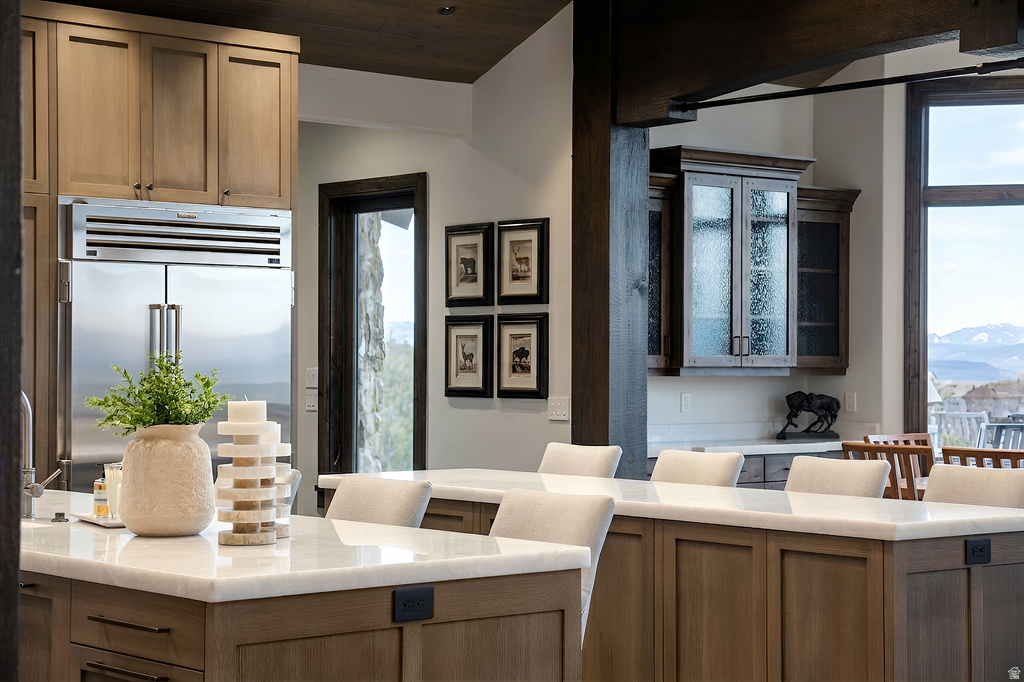 Kitchen island with light-toned wood cabinetry and white countertops