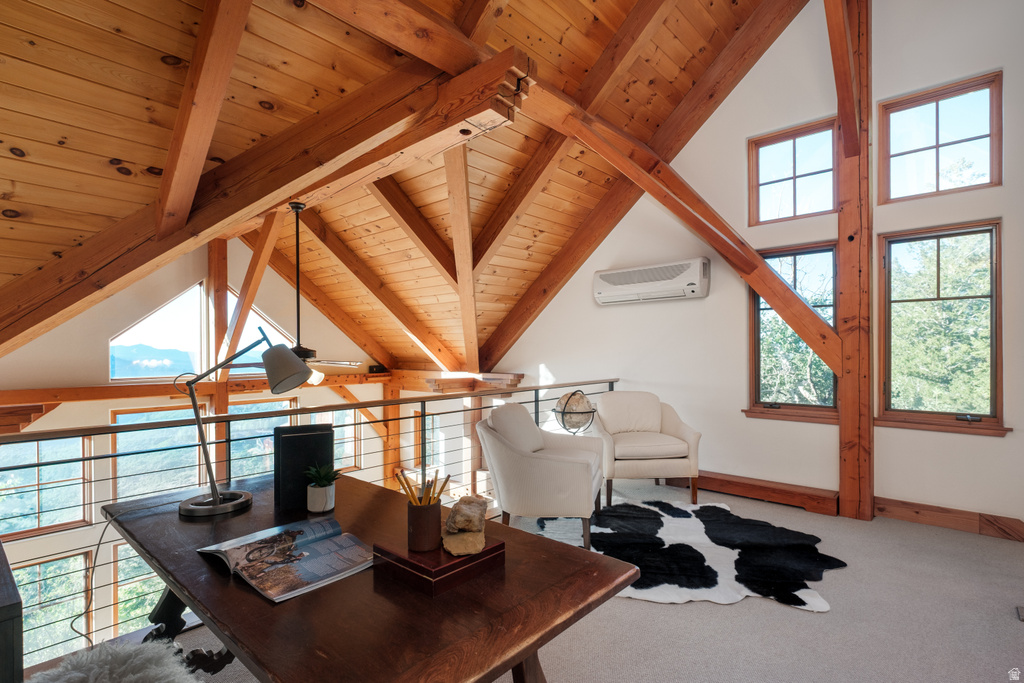 Open loft space featuring exposed wood beams and ceiling, multiple windows, and a cable railing