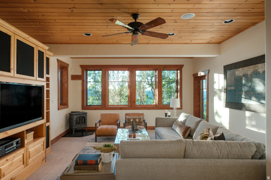 Living area featuring a natural wood plank ceiling with recessed lighting and a ceiling fan