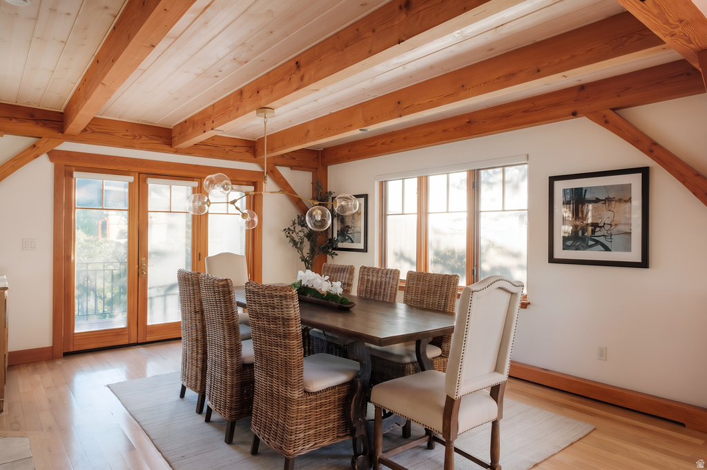 Dining area featuring a wood-finish ceiling with exposed beams, wood-finish flooring, and white walls