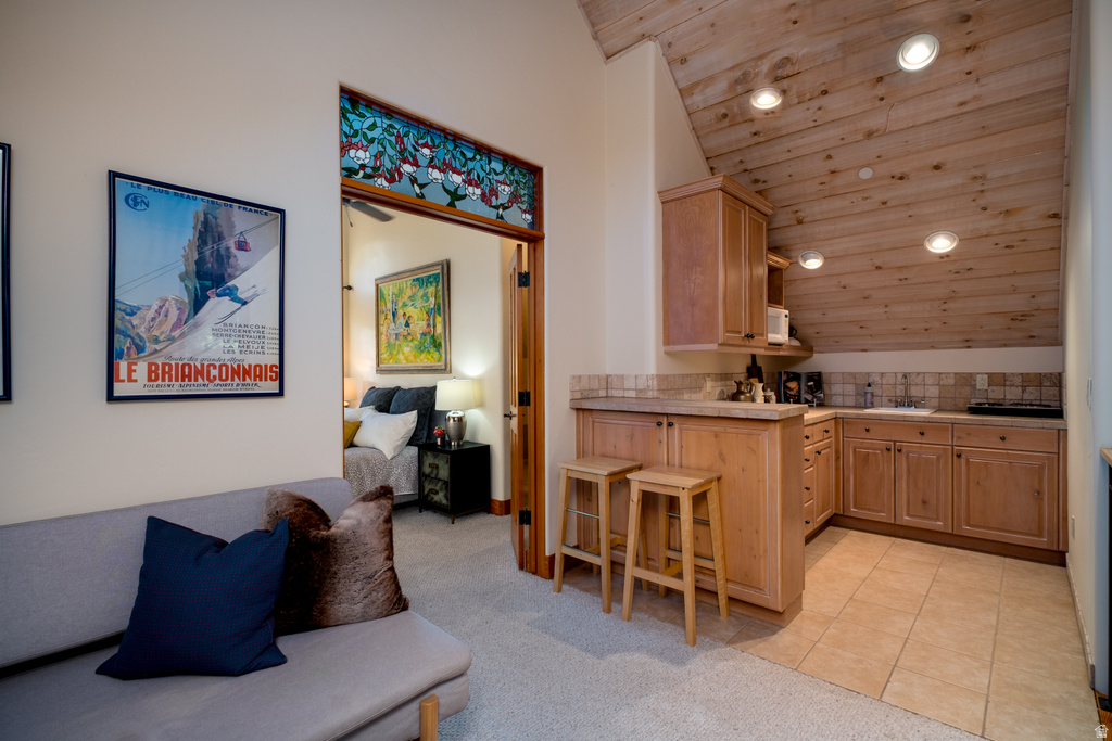 Compact kitchen area featuring wood cabinetry, tile flooring, and a tiled backsplash
