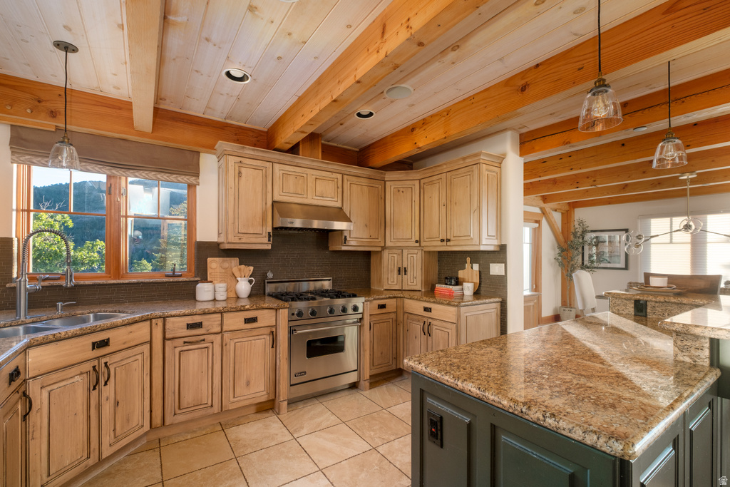 Kitchen featuring exposed wood beams, light wood cabinetry, stainless steel appliances, a corner sink, and a center island with granite countertops