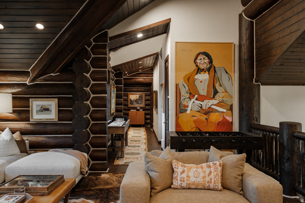 Log home interior featuring exposed log walls, coffered wood ceilings, and recessed lighting